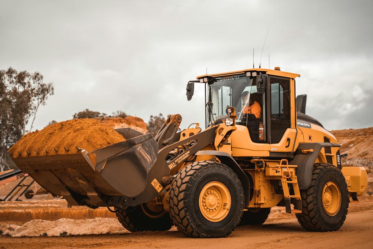 Wheel loader moving material at an open extraction site