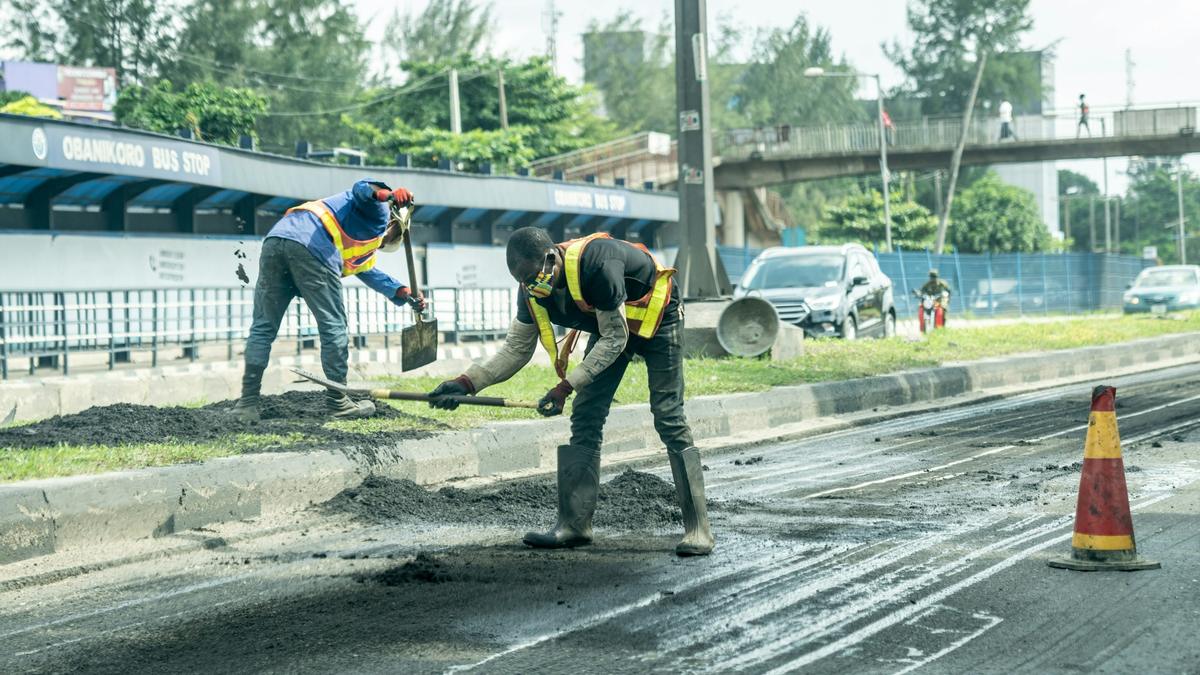 Construction workers in reflective jackets carrying out road works