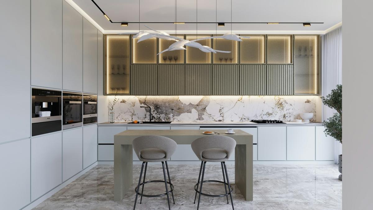 Kitchen with marble worktops, bar stools and concealed lighting