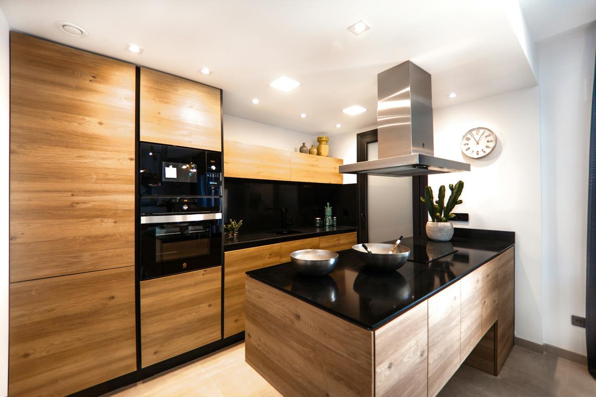 Modern kitchen with timber cabinetry and a black stone island