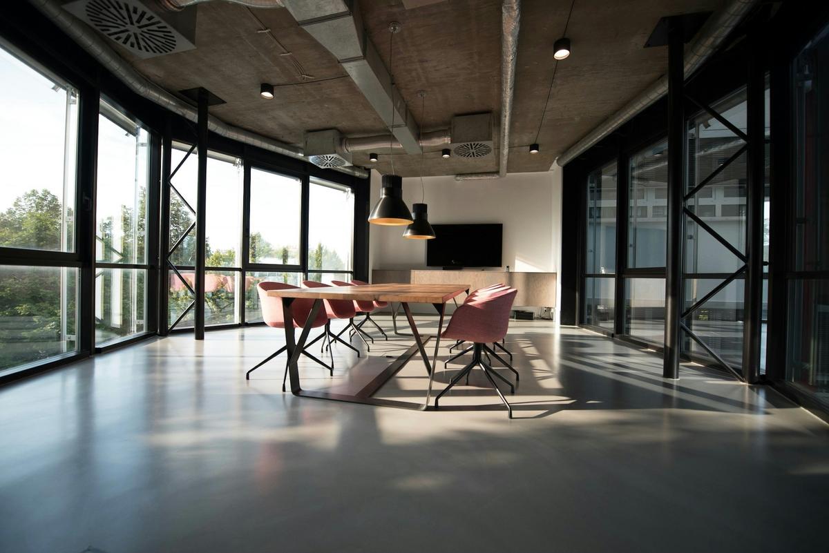 Open-plan office with polished concrete floor and floor-to-ceiling glazing
