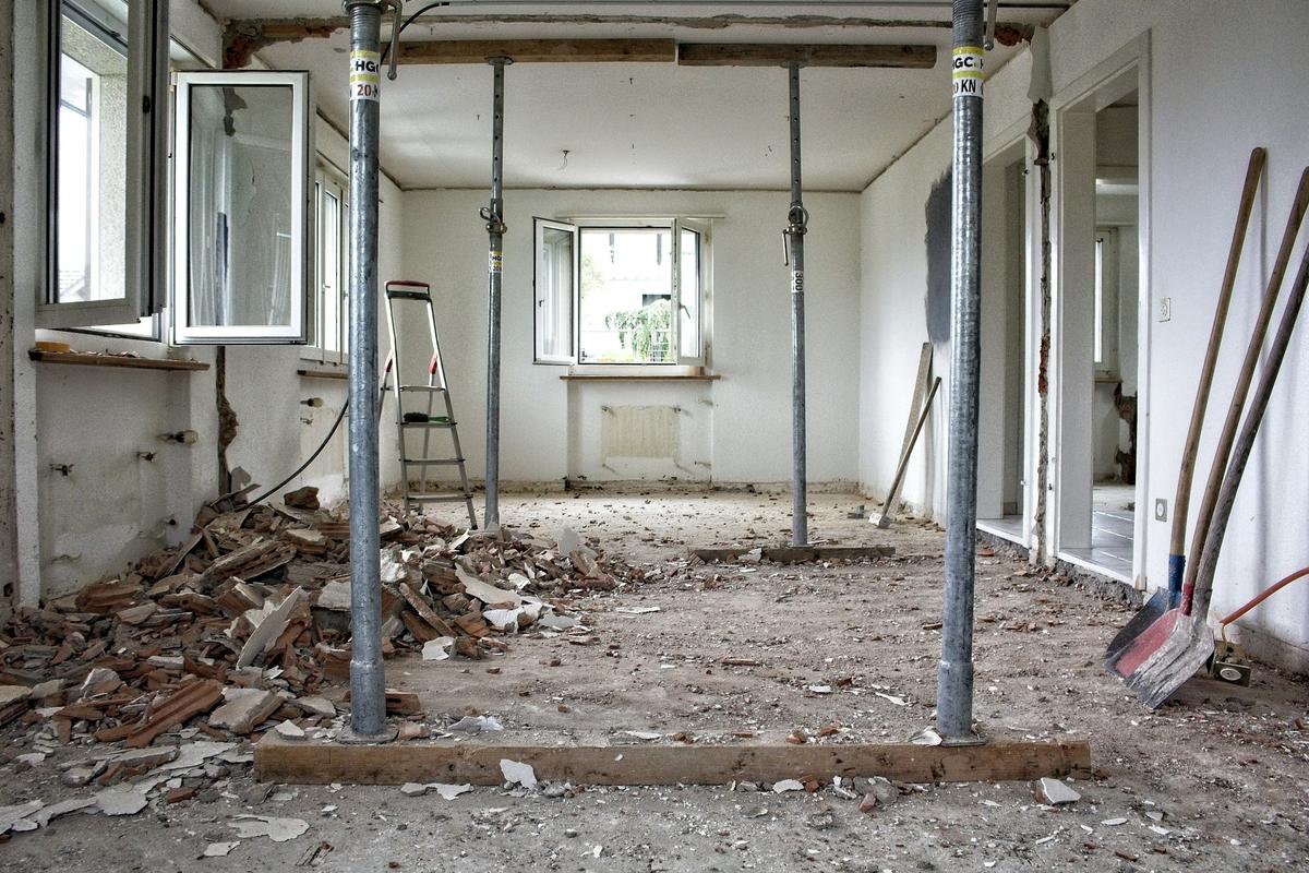 Room under renovation with temporary steel props supporting the ceiling