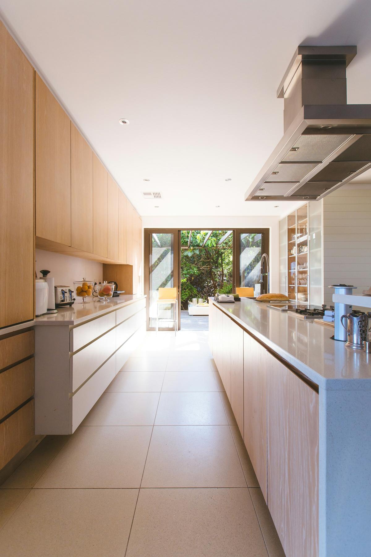 Bright finished kitchen with white cabinetry and an island